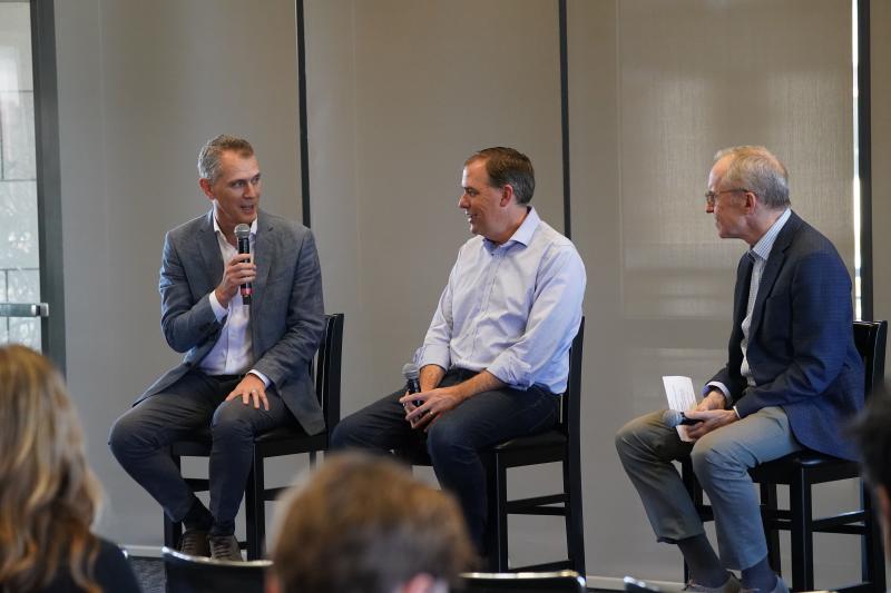 Studdert talking in panel with 2 other people